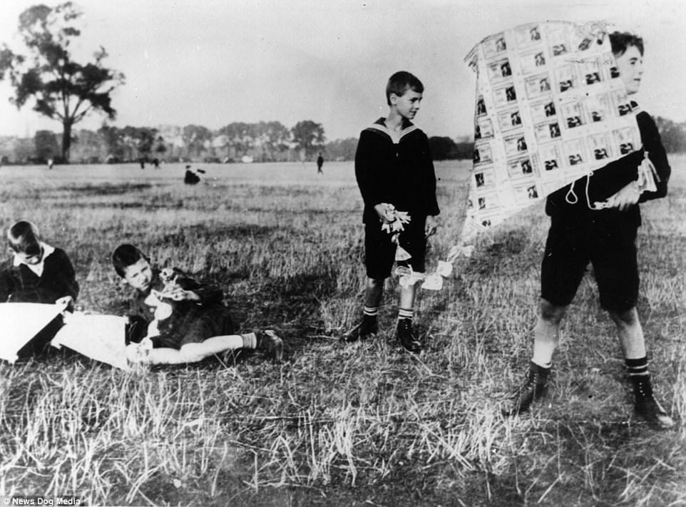 Children playing with kites made with worthless banknotes